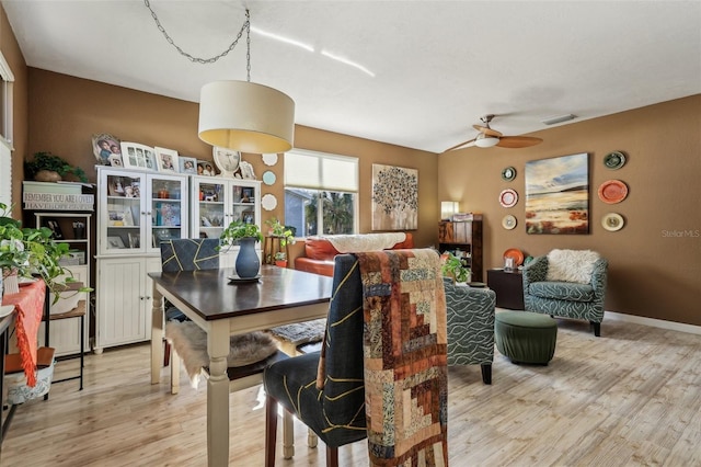 dining room featuring light hardwood / wood-style flooring and ceiling fan