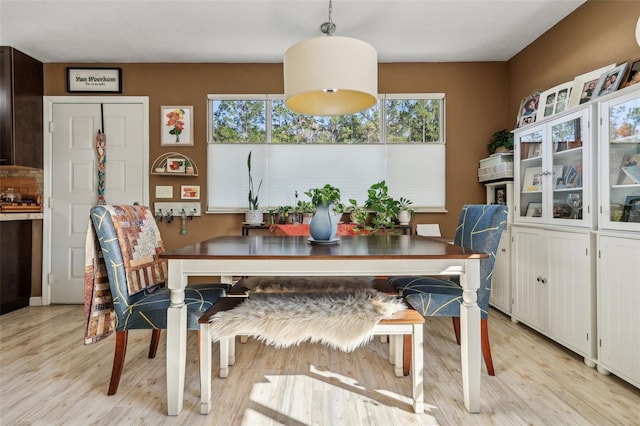 dining space with light hardwood / wood-style flooring