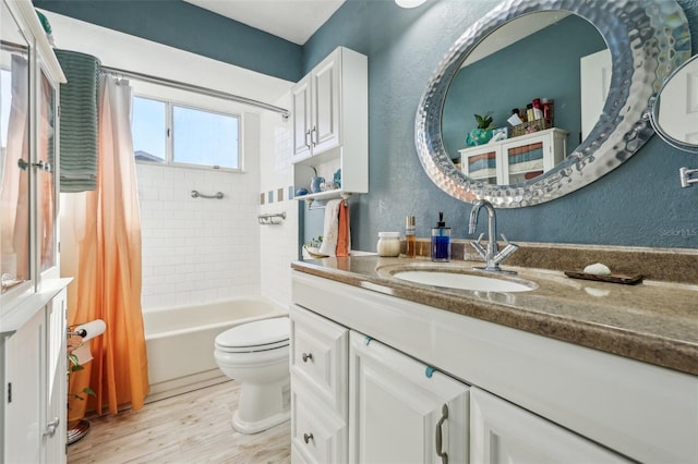 full bathroom with shower / bath combo, wood-type flooring, vanity, and toilet