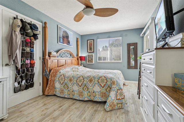 bedroom with ceiling fan and light wood-type flooring