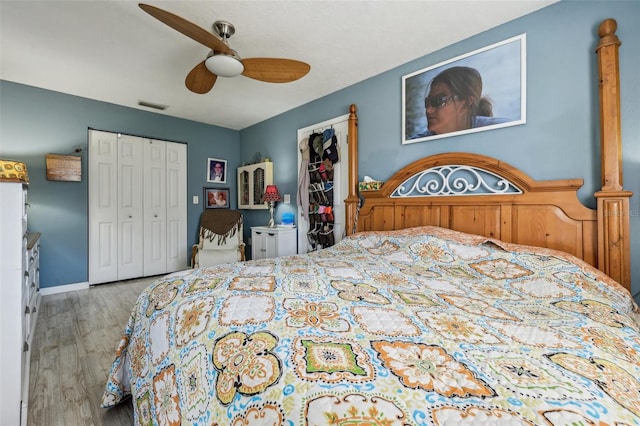 bedroom featuring light hardwood / wood-style floors, a closet, and ceiling fan