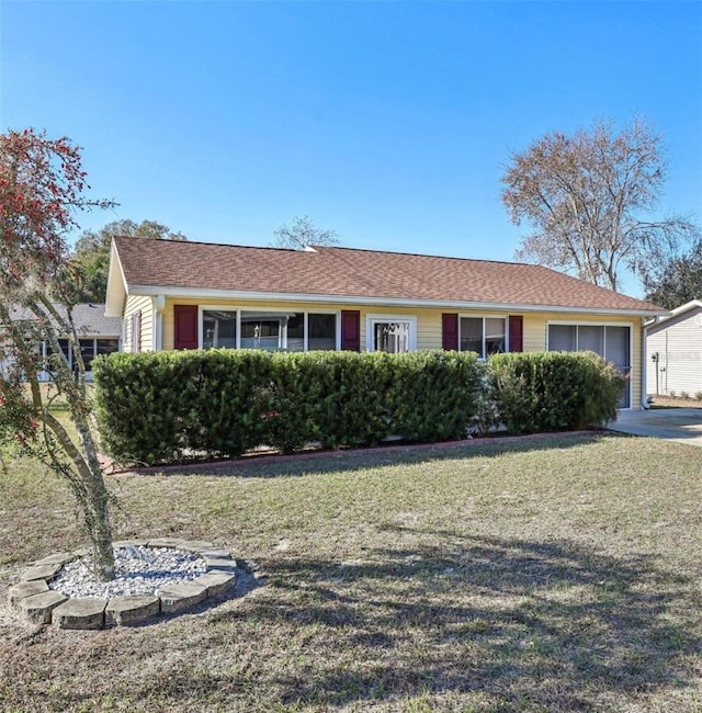 single story home with a garage and a front lawn