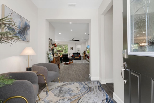 foyer with ceiling fan and dark hardwood / wood-style flooring