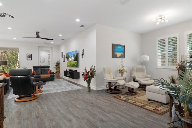 living room featuring hardwood / wood-style floors and ceiling fan