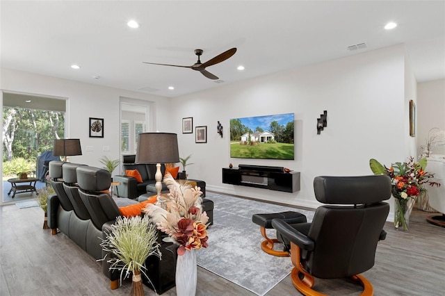 living room with ceiling fan and light hardwood / wood-style flooring