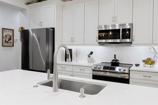 5477 N Princewood Dr, Beverly Hills, FL 34465 - kitchen featuring appliances with stainless steel finishes, light countertops, white cabinetry, and tasteful backsplash