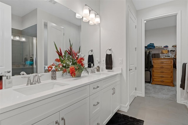 bathroom with tile patterned flooring, vanity, and an enclosed shower