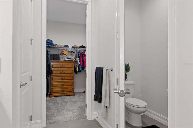 bathroom with tile patterned flooring and toilet