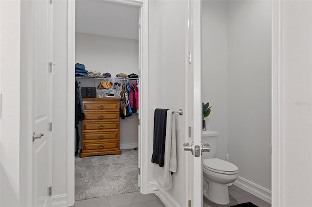 5477 N Princewood Dr, Beverly Hills, FL 34465 - bathroom featuring a walk in closet and tile patterned flooring