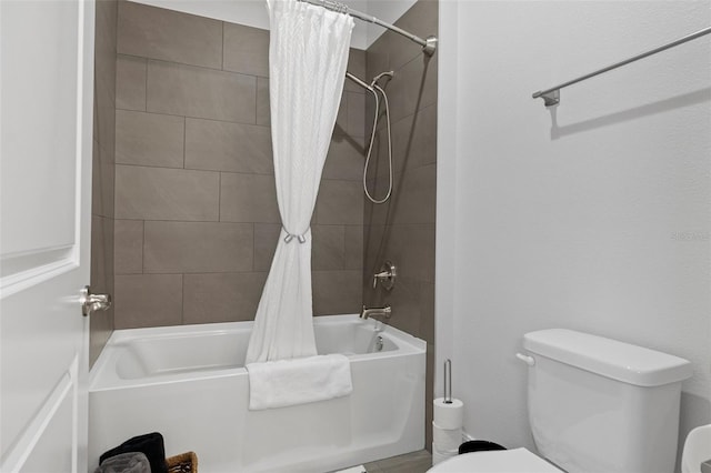 bathroom featuring toilet and shower / tub combo with curtain