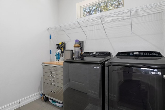 laundry room featuring washer and clothes dryer and tile patterned floors