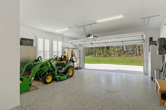 garage with a garage door opener and fridge