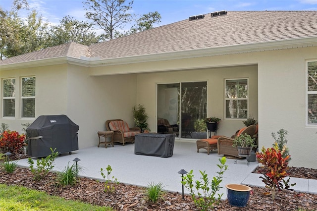 5477 N Princewood Dr, Beverly Hills, FL 34465 - rear view of property featuring a shingled roof, a patio area, stucco siding, and an outdoor living space