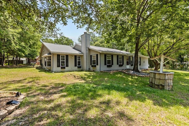 rear view of house with a lawn