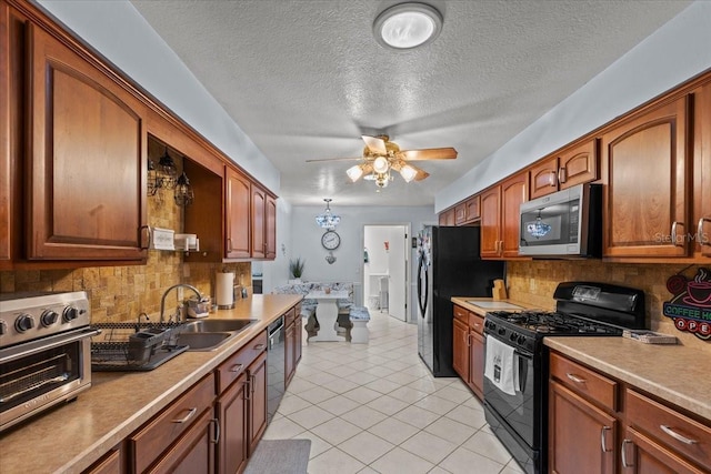 kitchen with backsplash, black appliances, sink, ceiling fan, and light tile patterned floors