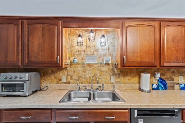 kitchen with dishwasher, tasteful backsplash, and sink