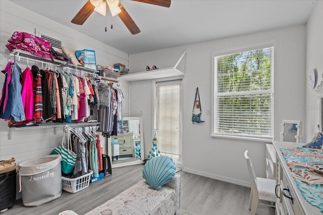 walk in closet featuring ceiling fan and light hardwood / wood-style floors