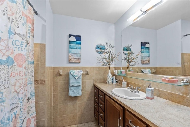 bathroom with tile patterned flooring, a shower with curtain, vanity, and tile walls