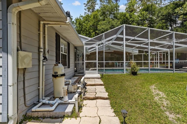 back of house with a lanai and a yard