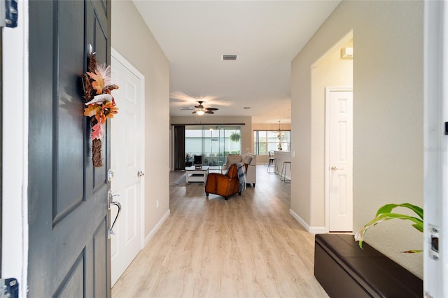 entrance foyer with ceiling fan and light hardwood / wood-style floors