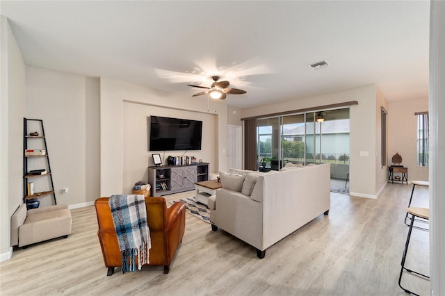 living room with ceiling fan and light wood-type flooring