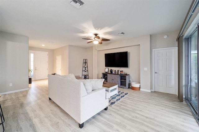 living room with light wood-type flooring and ceiling fan