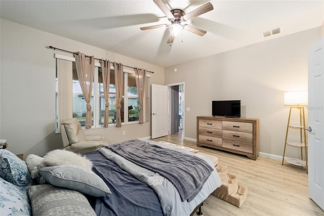 bedroom with ceiling fan and light hardwood / wood-style flooring