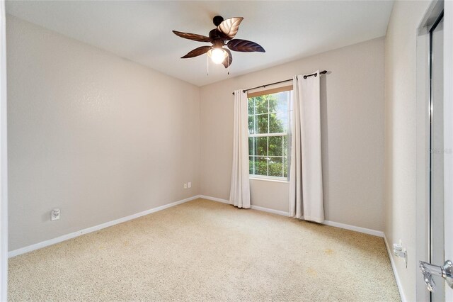 empty room with ceiling fan and carpet