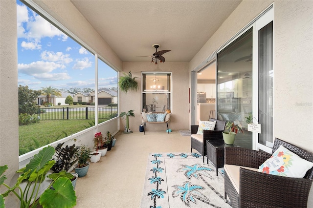 sunroom featuring ceiling fan