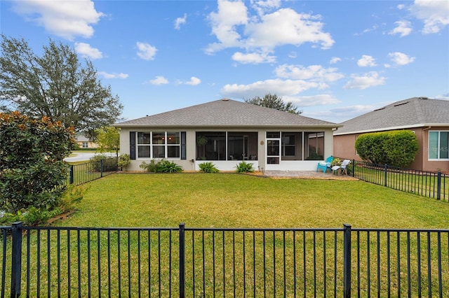 rear view of house featuring a yard, a patio area, and a sunroom