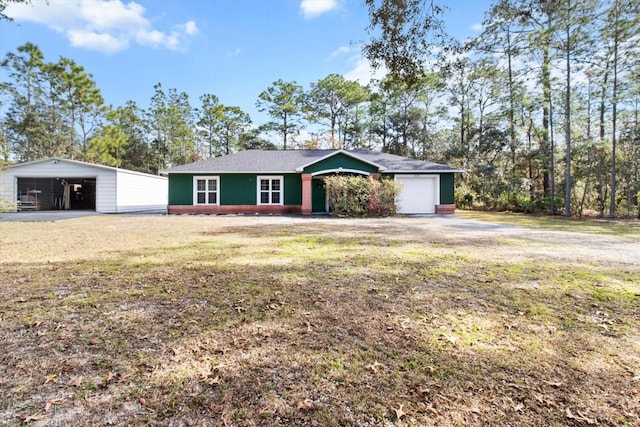 single story home featuring a front lawn and a garage