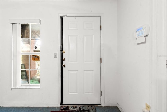 doorway to outside with carpet flooring