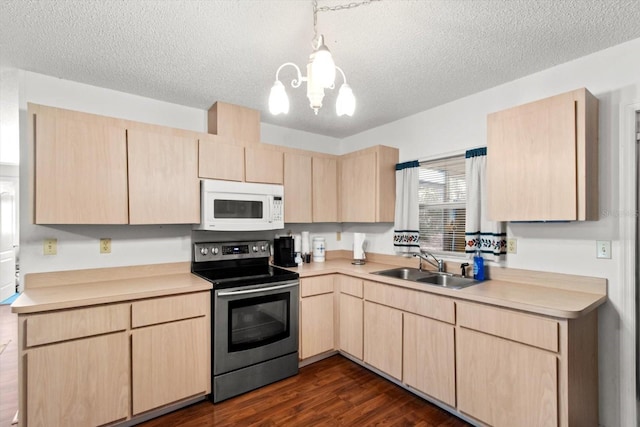 kitchen with stainless steel electric stove, light brown cabinetry, and an inviting chandelier