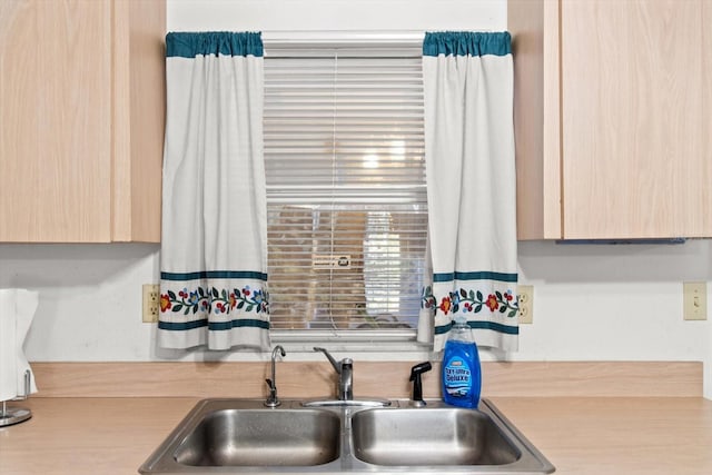 kitchen featuring light brown cabinetry and sink