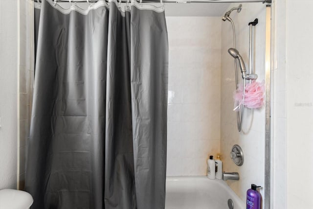 bathroom featuring toilet and shower / bathtub combination with curtain