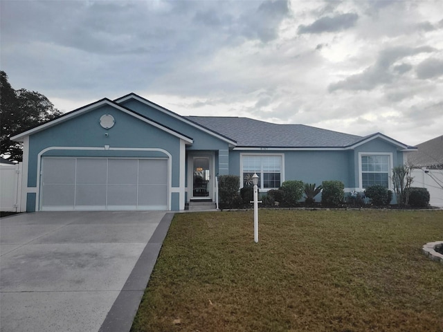 ranch-style home featuring a front lawn and a garage