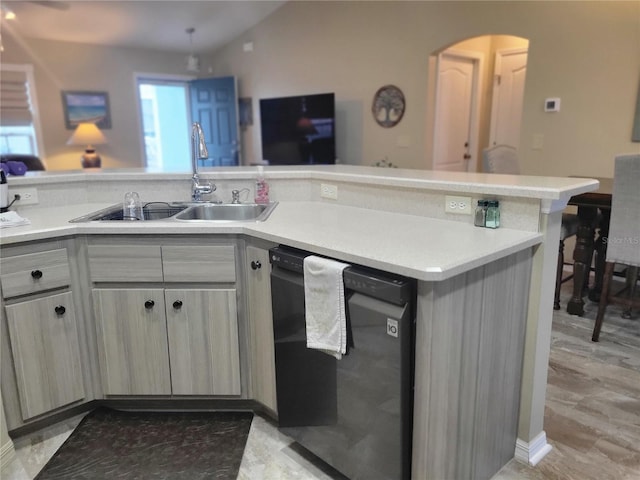 kitchen with kitchen peninsula, sink, lofted ceiling, and black dishwasher