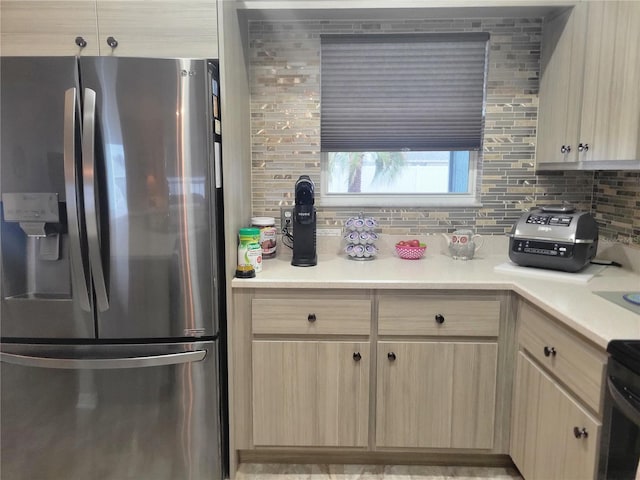 kitchen featuring tasteful backsplash, stainless steel fridge with ice dispenser, and light brown cabinets