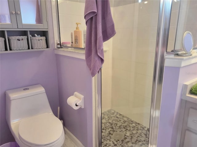 bathroom with toilet and an enclosed shower