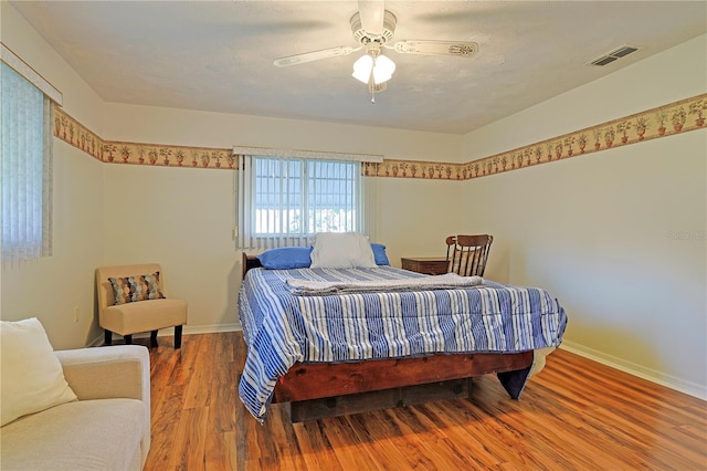 bedroom featuring hardwood / wood-style flooring and ceiling fan