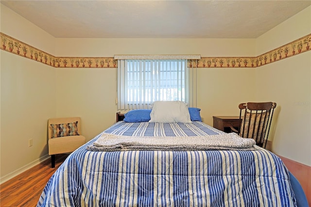 bedroom with hardwood / wood-style floors