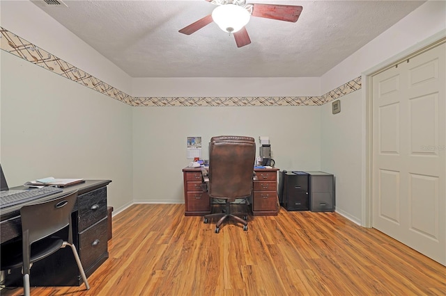 office space featuring ceiling fan, a textured ceiling, and light hardwood / wood-style flooring