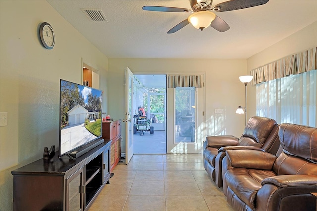 tiled living room with ceiling fan