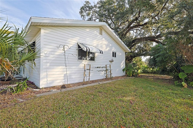 view of property exterior with a lawn