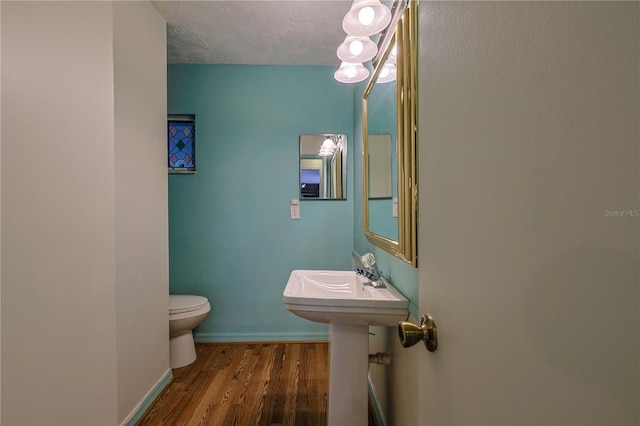 10185 SE 175th Ln, Summerfield, FL 34491 - half bathroom with toilet, wood finished floors, a textured ceiling, and baseboards