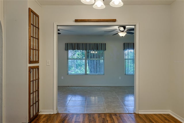 10185 SE 175th Ln, Summerfield, FL 34491 - tiled empty room with ceiling fan, baseboards, and a chandelier