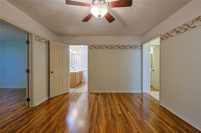 10185 SE 175th Ln, Summerfield, FL 34491 - unfurnished room featuring wood finished floors, a textured ceiling, baseboards, and a ceiling fan