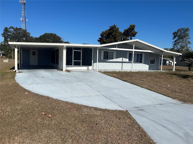 view of front of property with a carport and a sunroom