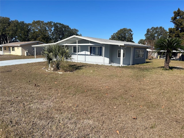 ranch-style house with a front lawn and a carport