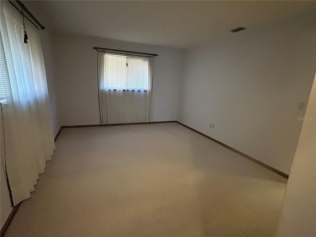 spare room with light carpet